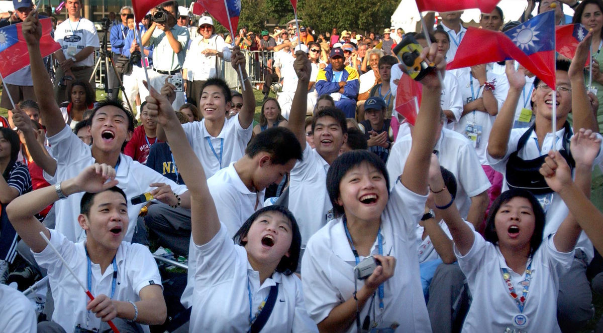Second Place, Team Picture Story - Tracy Boulian / The Plain DealerMembers of the Taipei, Taiwan, team wave their flags during the closing ceremonies of the International Children's Games.   
