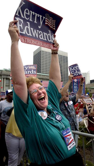Third Place, Team Picture Story - Chris Stephens / The Plain DealerClare Votava, of Avon, Ohio cheers as Sens. John Kerry and John Edwards take the stage at Mall C in downtown Cleveland to make their first public campaign appearance together since John Edwards agreed to become democratic presidential candidate Kerry's running mate. 