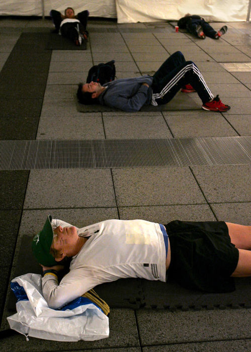 First Place, Team Picture Story - Ed Suba Jr. / Akron Beacon JournalBarb Stevenson of Mentor relaxes with several other runners while waiting to compete in the 2004 Road Runner Akron Marathon on October 2, 2004. 