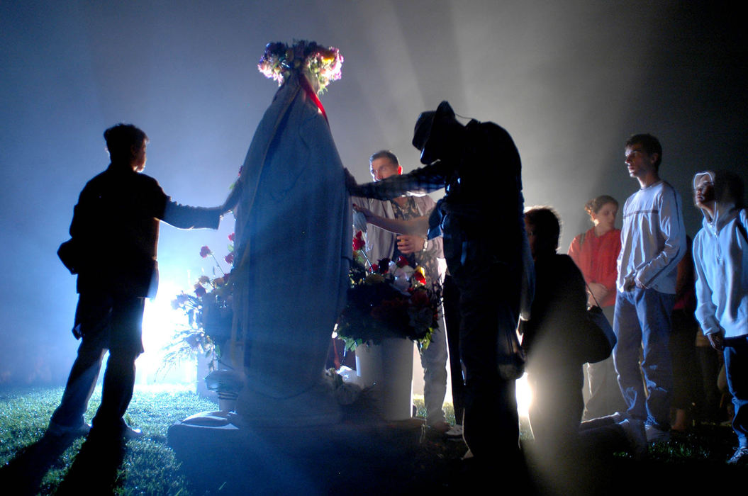 Award of Excellence, Assigned Feature - Tim Harrison / Tim HarrisonBelievers place their hands on a statue of the the Virgin Mary just after midnight September, 15, 2005, on a hill in Eaton Township. A few thousand people came by bus and car to see a scheduled apparition of Mary at midnight on the grounds of the Holy Love Ministries,