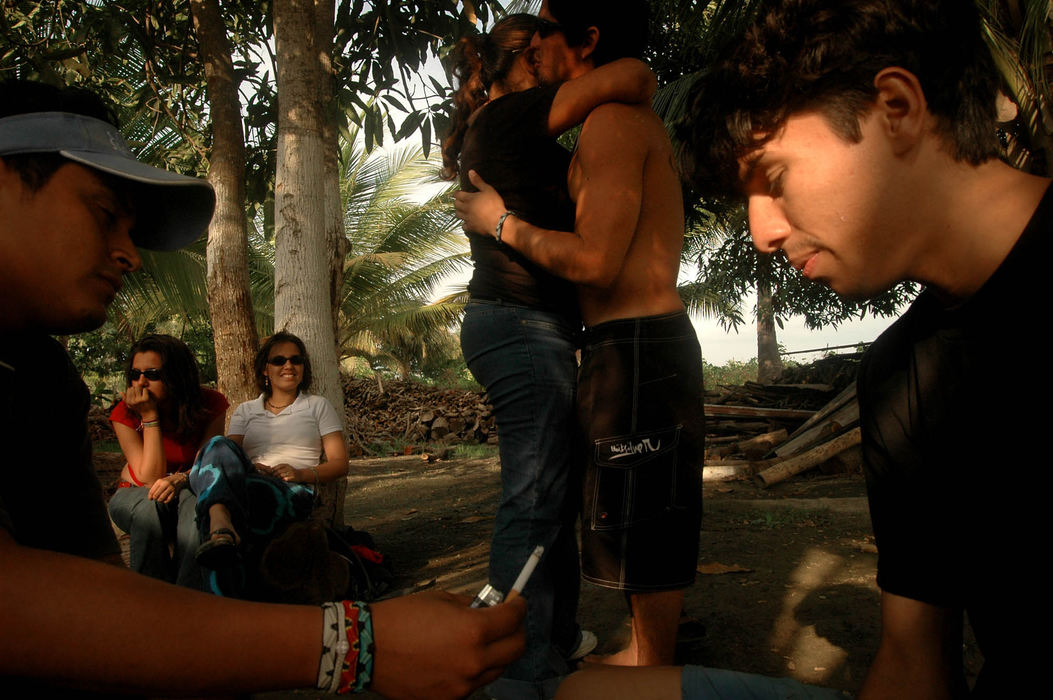 Award of Excellence, Enterprise Feature - Tim Harrison / FreelanceJackson (left) offers his friend Mario a cigarette while spending the day drinking caña, a cruder version of rum, and dancing on a hacienda, or finca, in the lowland country of Rocafuerte, Ecuador, with friends.