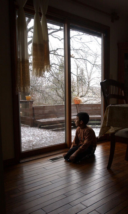 Second Place, Feature Picture Story - Karen Schiey / Akron Beacon JournalMajid looks out the window at the snow as he recovers from surgery at the home of his host family in Kent.