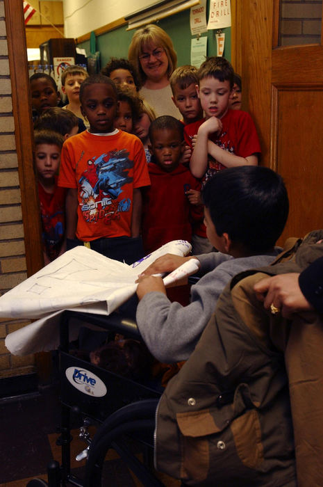 Second Place, Feature Picture Story - Karen Schiey / Akron Beacon JournalMajid is wheeled by the first grade class of Carol Gughron after Majid's visit to Barber Elementary School in Akron.