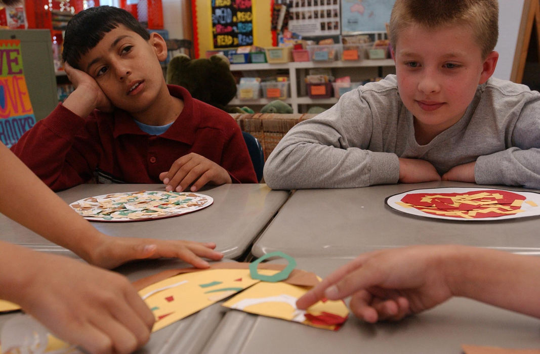 Second Place, Feature Picture Story - Karen Schiey / Akron Beacon JournalKnowing very little English, Majid does not understand the class lesson on fractions using a cardboard pizza.