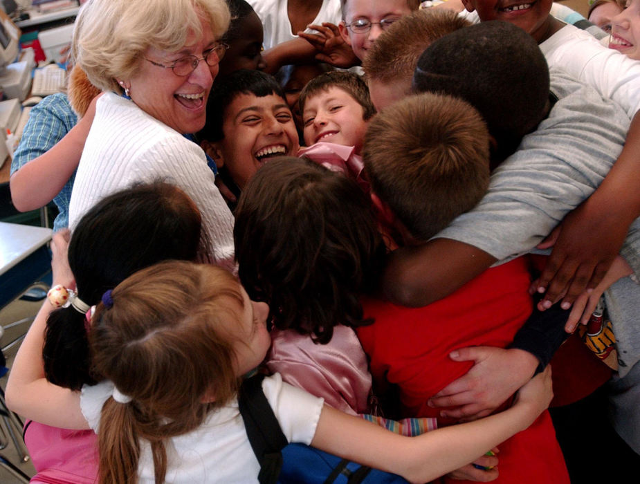Second Place, Feature Picture Story - Karen Schiey / Akron Beacon JournalMajid is hugged by classmates and third grade teacher Gretchen Sues at the  end of his last day of school at Holden Elementary. He would be returning home to Iraq the next day.