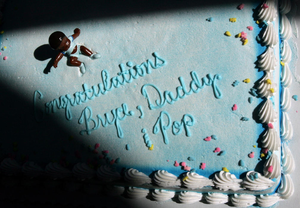 Third Place, Feature Picture Story - Chris Russell / The Columbus DispatchIn November 2004 the Ohio legislature passed a Defense of Marriage Act that banned gay marriage.  In 2005 they were considering legislation that would ban gay adoptions.  Jim Olive and partner Rodney Sweigart choose to adopt an infant after years of fostering. Jim Olive's co-workers made a cake to celebrate the adoption of Bryce by Jim and his partner Rodney Sweigart. The cake was displayed at a baby shower held for the new family at Jim's work place.  