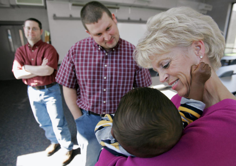 Third Place, Feature Picture Story - Chris Russell / The Columbus DispatchProud parents, Rodney Sweigart and Jim Olive (left to right) look on as one of Jim's co-workers  plays with Bryce at a baby shower held at the college where Jim teaches.  