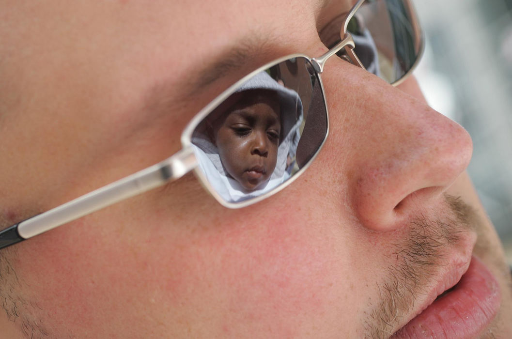 Third Place, Feature Picture Story - Chris Russell / The Columbus DispatchBryce is reflected in Jim's sunglasses as the family waits for the Annual Aids Walk to begin.  Although Columbus remains a gay friendly town, statewide politics and policy seem to be working against gay issues.  