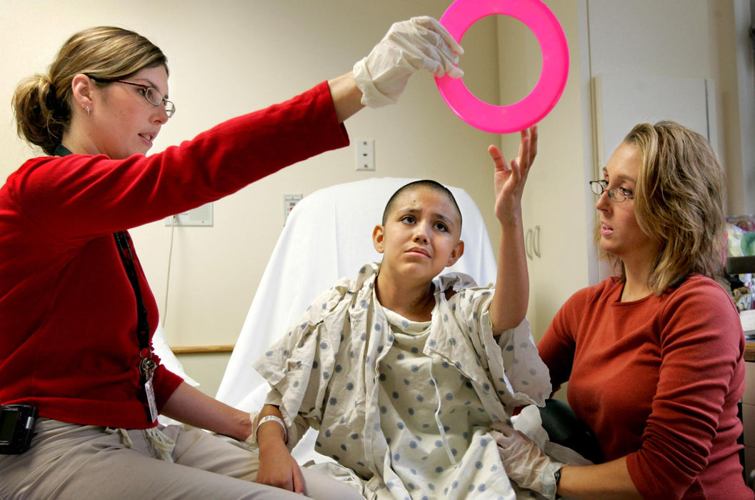 Award of Excellence, Feature Picture Story - David I. Andersen / The Plain DealerAfter a week in intensive care, Heidi began to work with Cleveland Clinic therapists Pamela Pierson and Karen Vitak. Heidi lost motion on her right side and ability to speak.