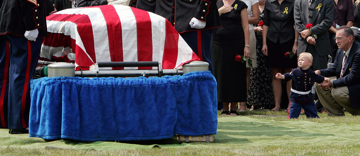 First Place, General News - Mike Levy / The Plain DealerOne-year-old Alexander Montgomery, dressed in a Marine uniform, looks to the casket bearing his father, Lance Cpl. Brian Montgomery, of Mentor. The Marine Reservist was one of 48 members of a Brook Park-based unit killed in Iraq in 2005