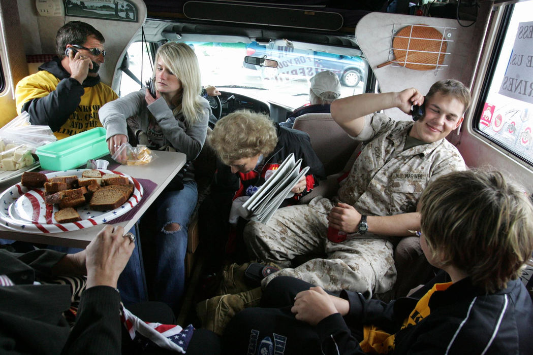 Award of Excellence, General News - Fred Squillante / The Columbus DispatchWord spreads on cell phones that Marine Lance Cpl. James "Jamie" Crum is home from Iraq. Seated in their RV as they drive from the airport to their home are, from left: Crum's uncle, Mike Hance; Crum's girlfriend Melissa Hoak; Crum's grandmother Sandy Bumgarner; and James Crum. James Crum is a member of Lima Company, which lost 16 Marines in Iraq.