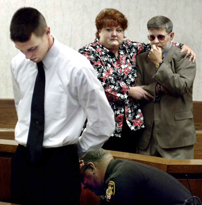 Award of Excellence, General News - Jeff Forman / News-HeraldJames Hickey (right) is comforted by his sister-in-law Lorie Froelich as  Hickey's son James Hickey III is shackled after being sentenced by Lake County Common Pleas Judge Vincent A. Culotta to three years in prison for robbing a pizza delivery man.