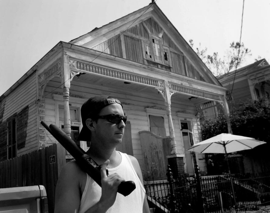 First place, News Picture Story - Dale Omori / The Plain DealerArmed with a sawed-off shotgun, Phil Borges stands guard against looters, Sept. 5, 2005, New Orleans, La. Most of the city has been evacuated.  Borges was escorting a friend as she collected her belongs.  Behind Borges is the apartment house where Lee Harvey Oswald stayed.  