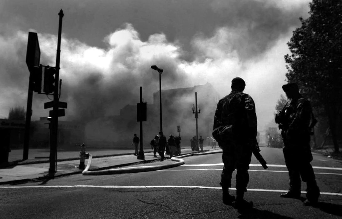 First place, News Picture Story - Dale Omori / The Plain DealerMembers of the U.S. Army 82nd Airborne patrol an intersection in downtown New Orleans Wednesday, Sept. 7, 2005, New Orleans, La.  Numerous fires have broken out throughout the city in the aftermath of Hurricane Katrina.  Low water pressure and areas still flooded have hampered efforts fighting the fires. 