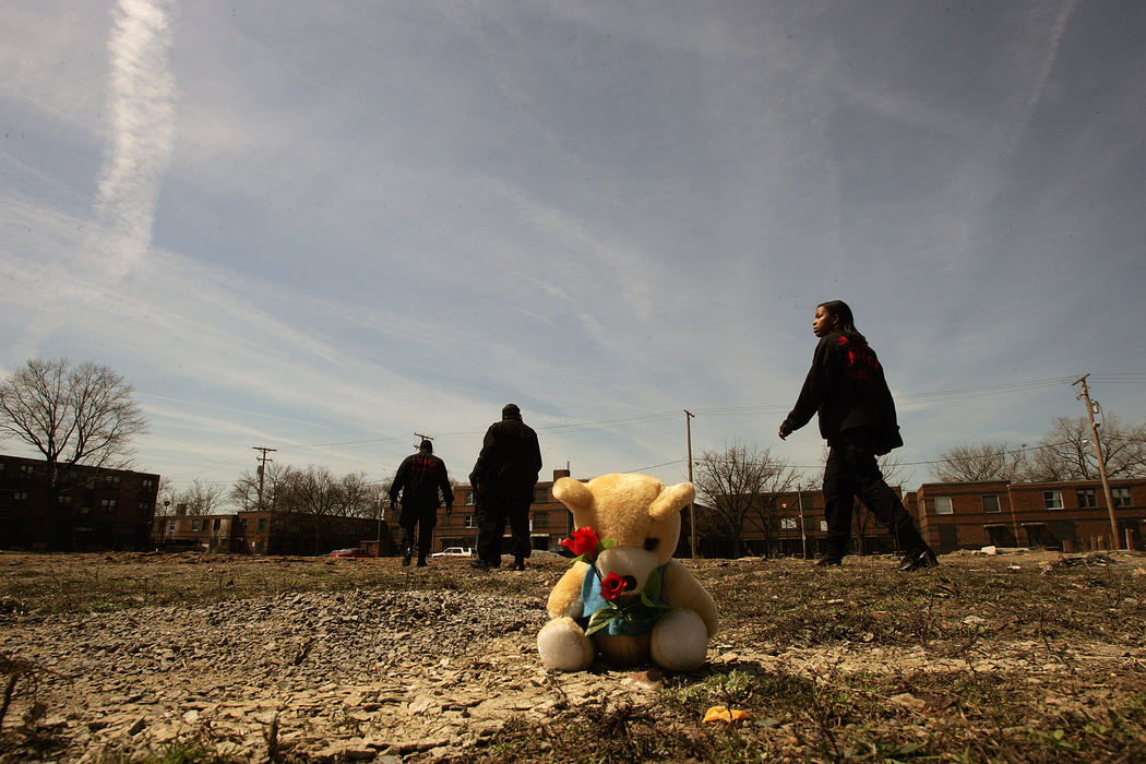 Third Place, News Picture Story - Mike Levy / The Plain DealerMembers of the community task force walk around the area where 11-year-old  Brandon Davis was fatally shot near a playground at the Outhwaite housing project in Cleveland. 
