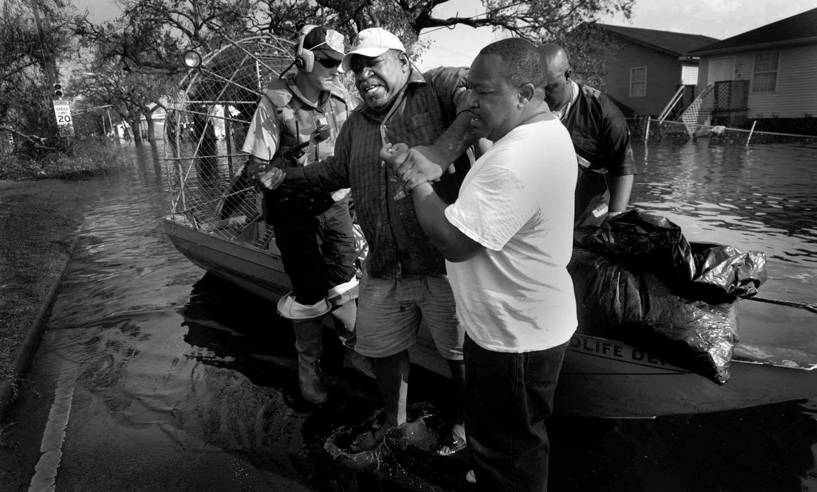 First place, News Picture Story - Dale Omori / The Plain DealerDwight Williams, 59, is helped out of an air boat after being taken back to his home the flooded out Arabi section of New Orleans to retrieve medication, Sept. 4, 2005.