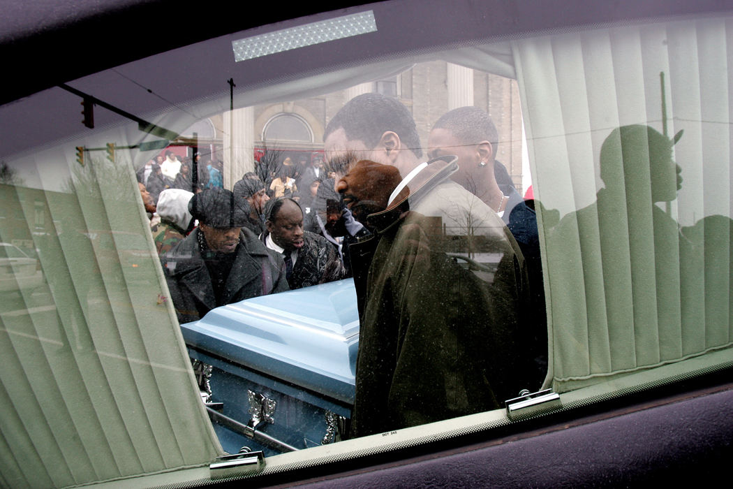 Third Place, News Picture Story - Mike Levy / The Plain DealerLennard Pinson's body is carried from Shiloh Baptist Church to the awaiting hearse. 