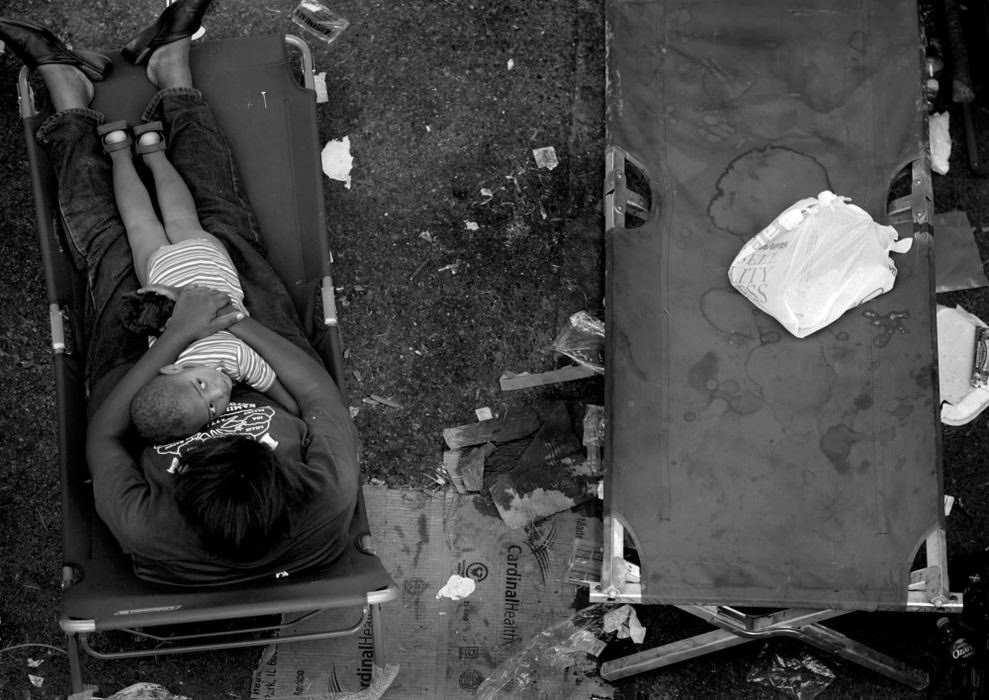 First place, News Picture Story - Dale Omori / The Plain DealerA young boy and his mother await evacuation from New Orleans.  They were living beneath a highway overpass.                               