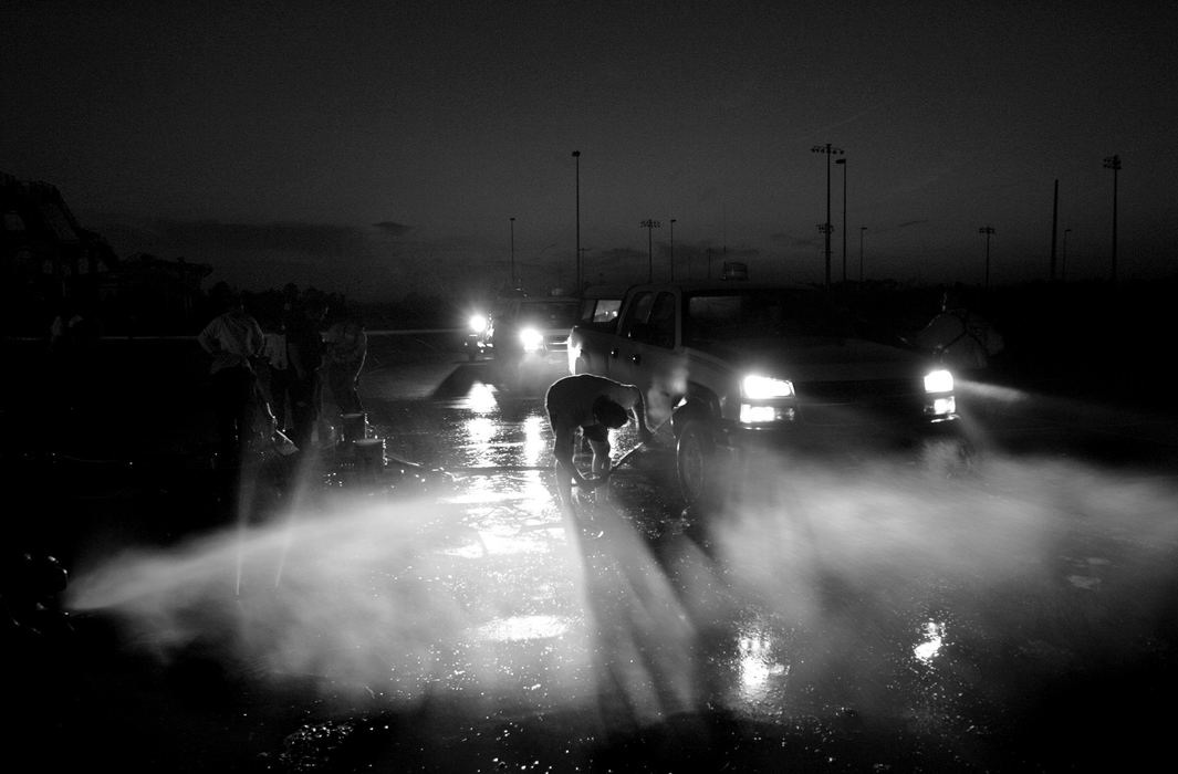 Award of Excellence, News Picture Story - Jpshua Gunter / The Plain Dealer After a long day in the field, FEMA Ohio Task Force 1 return to their Base of Operation for a decontamination spray down in Gulfport, Mississippi, September 03, 2005. 