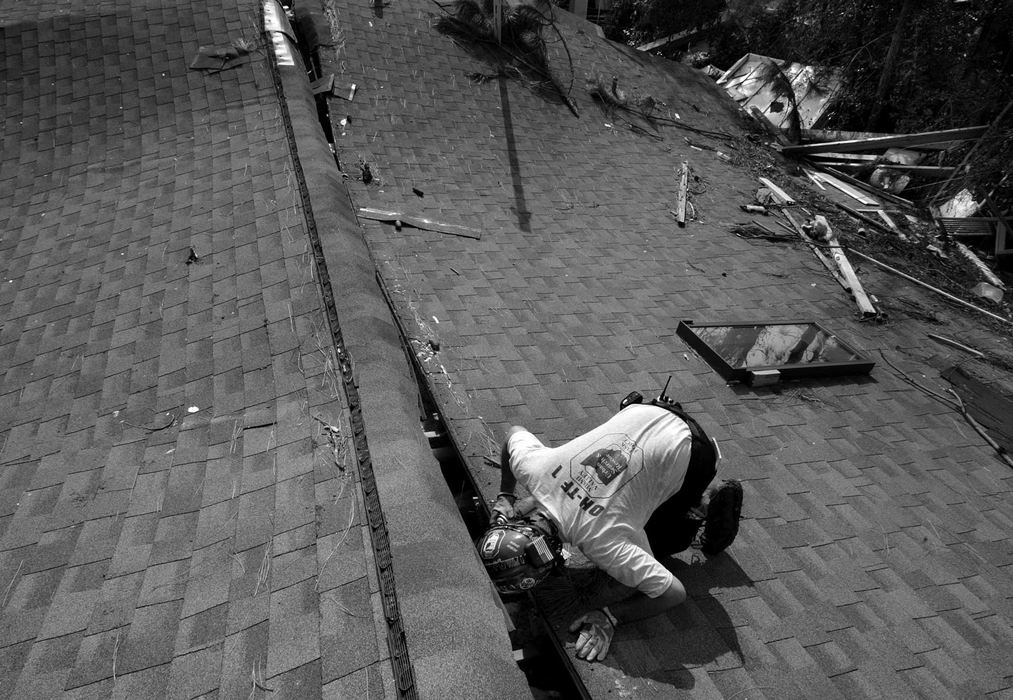 Award of Excellence, News Picture Story - Jpshua Gunter / The Plain DealerDoug Cope,  with the FEMA Ohio Task Force 1, calls out for survivors into an attic of a collapsed home in Pas Christian, Mississippi, September 03, 2005. 