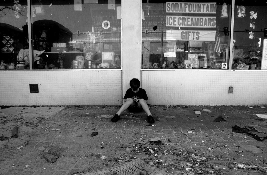 Award of Excellence, News Picture Story - Jpshua Gunter / The Plain DealerDaniel Lindsey, 8, passes some time playing a video game outside Triplett Day drug store where his siblings were getting paid to help clean the flooded store in Gullfport, Mississippi, September 04, 2005.