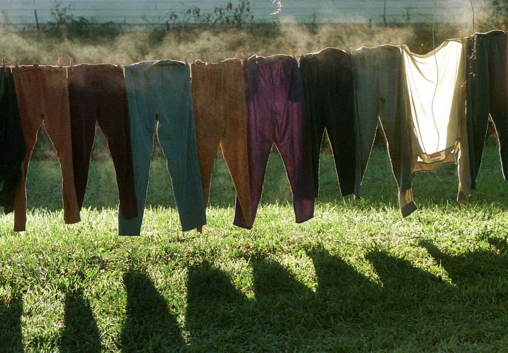 First place, James R. Gordon Ohio Understanding Award - Gary Harwood / Kent State UniversityWet pants, cold air and the morning sun create steam as the backlit pants glow against the shaded wall of a garage near Chapman Camp.