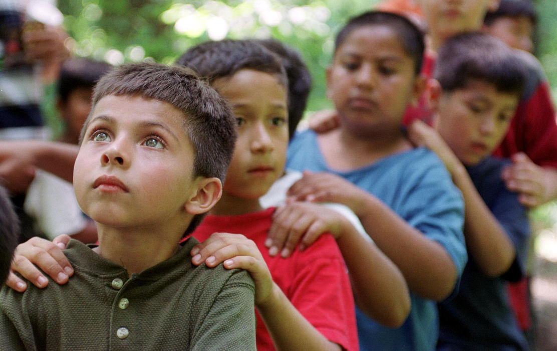 First place, James R. Gordon Ohio Understanding Award - Gary Harwood / Kent State UniversityChristian Vela, Jose Medina and Erik Flores participate in a team-building exercise during a day trip. Vela, in the front, listens attentively to the instructions of the camp leader.