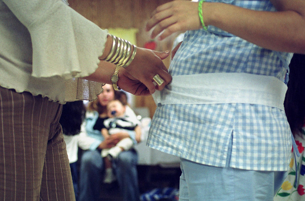 First place, James R. Gordon Ohio Understanding Award - Gary Harwood / Kent State UniversityGuests at Maribel Diaz’s baby shower take their best guesses at the size of her expectant belly. Maribel gave birth to a baby boy a few weeks later.