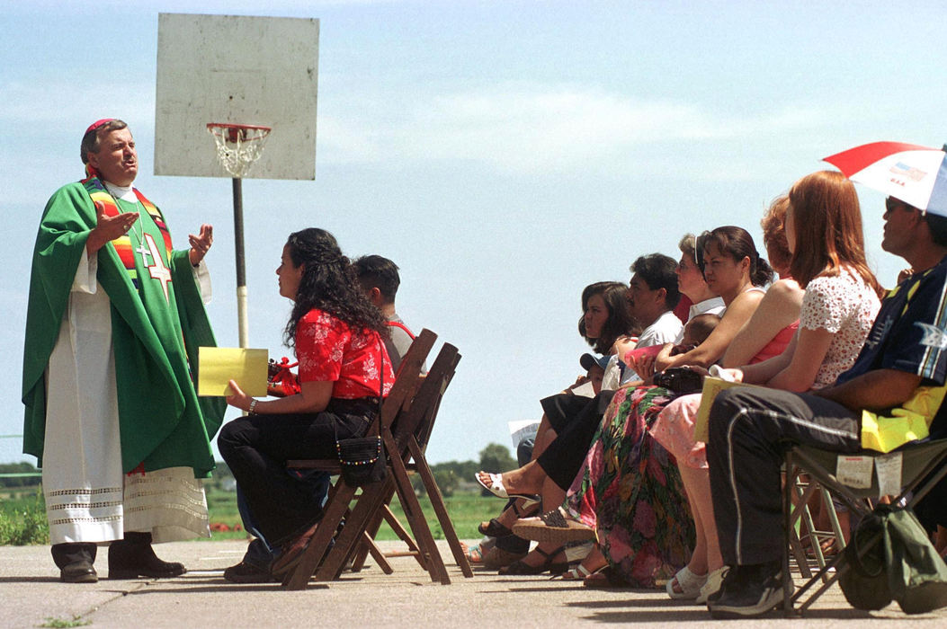 First place, James R. Gordon Ohio Understanding Award - Gary Harwood / Kent State UniversityIn an opportunity of a lifetime, Bishop John Manz celebrates mass on a basketball court near migrant housing on the Zellers Farm. Bishop Manz is the liaison to migrant ministries for the U.S. Catholic Conference of Bishops.  