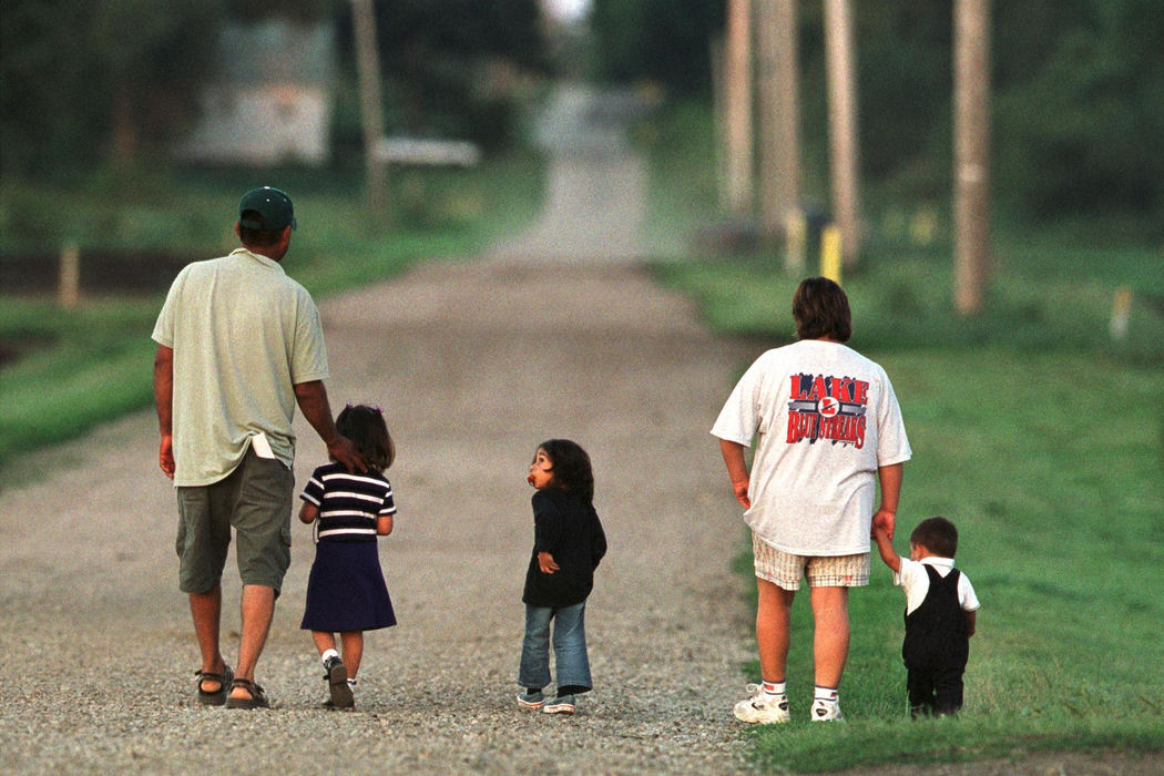 First place, James R. Gordon Ohio Understanding Award - Gary Harwood / Kent State UniversityMariano, Kaylee, Samantha, Monica and Ezequiel Delgado take advantage of a peaceful evening and go for a walk on a gravel road that borders the Brenckle and Zellers farms. Because the growers adhere to normal work hours, migrant parents have an opportunity to spend quality time with their children after a day in the fields.