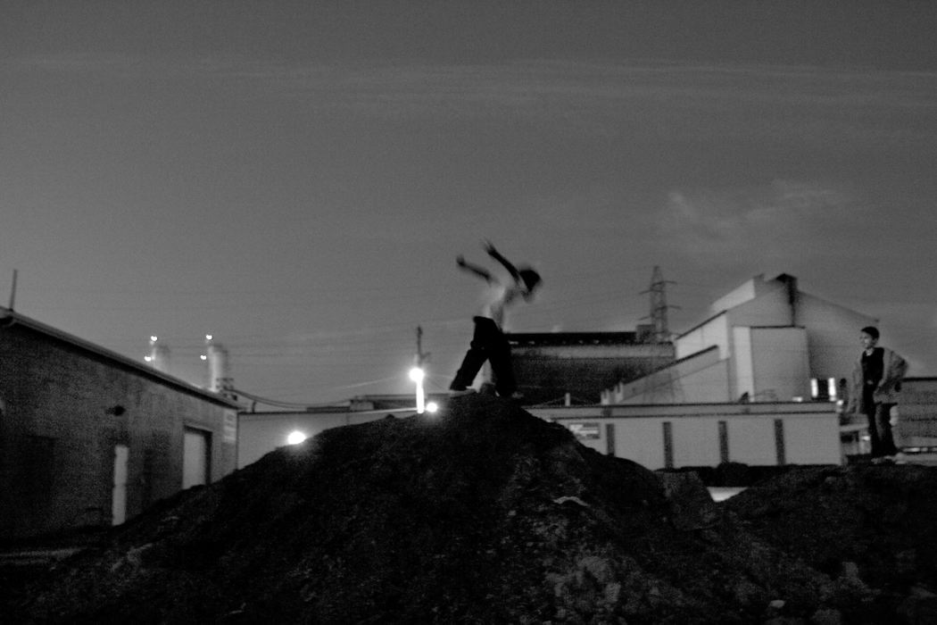 Second Place, James R. Gordon Ohio Understanding Award - Mike Levy / The Plain DealerChildren play on a mound of dirt just south of 28th street in Lorain.  In the background is Republic steel another industry in Lorain on its way out.