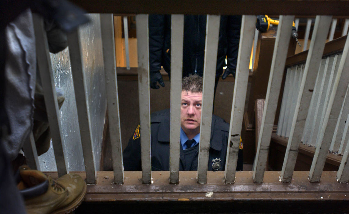 Third Place, George S. Smallsreed Photographer of the Year Award - Gus Chan / The Plain DealerAl Humphrey pauses on the stairway to offer a landlord a few tips during an eviction.