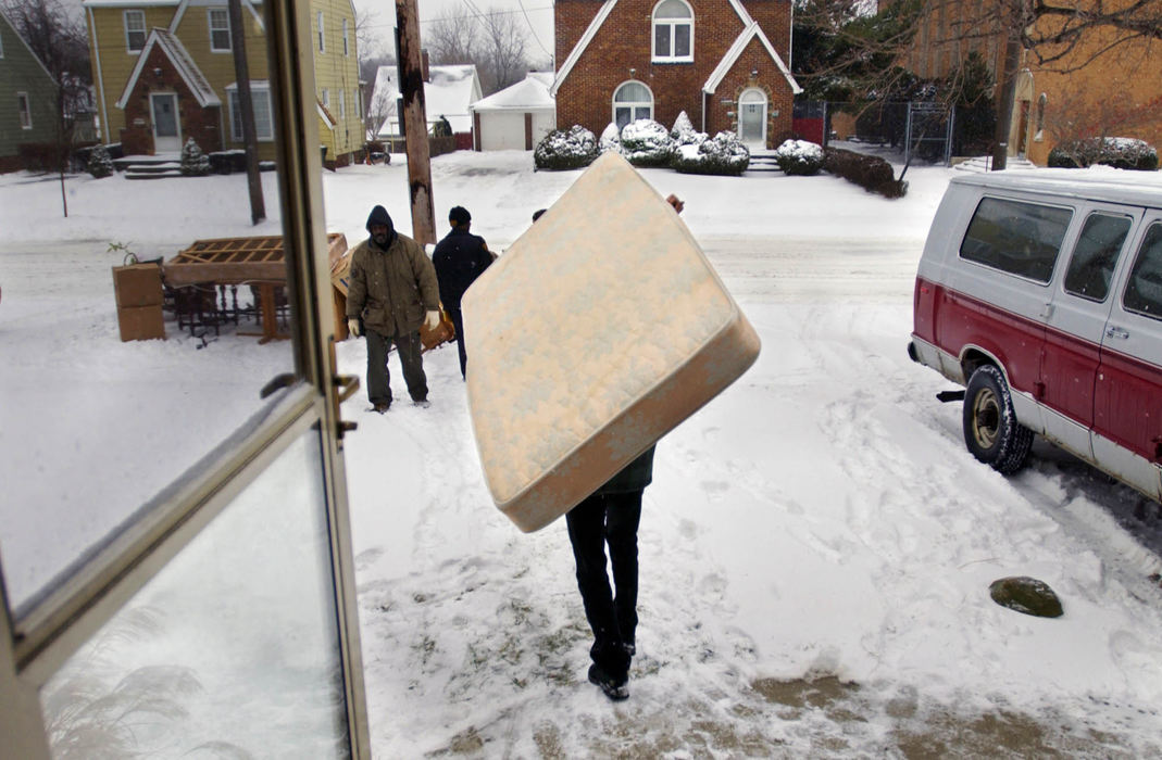 Third Place, George S. Smallsreed Photographer of the Year Award - Gus Chan / The Plain DealerA mover carries a mattress to the tree lawn during an eviction.