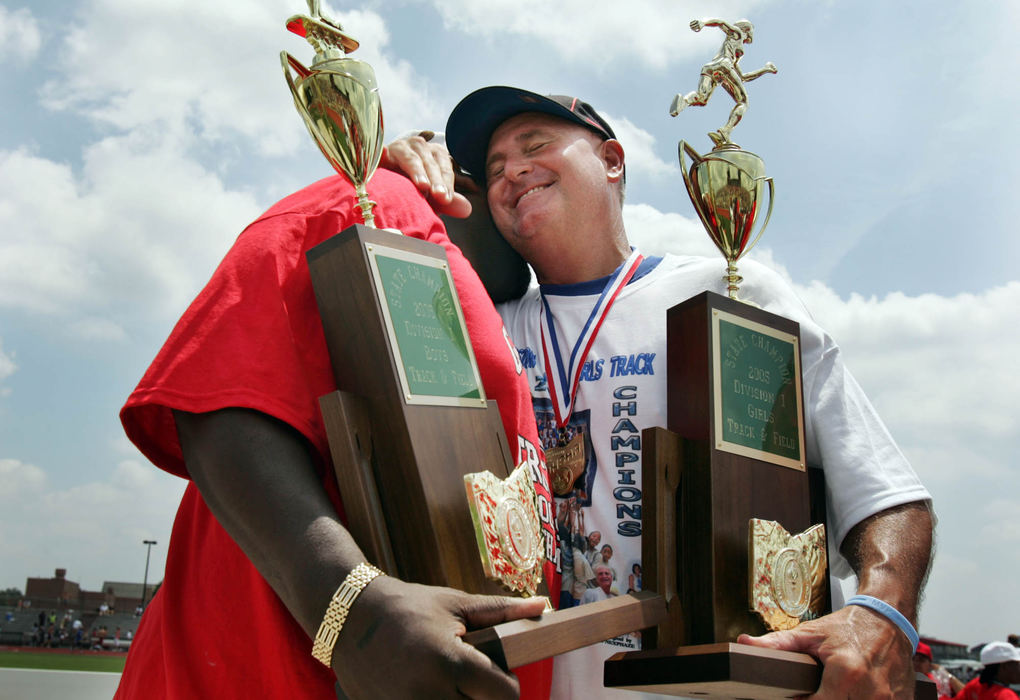 Third Place, George S. Smallsreed Photographer of the Year Award - Gus Chan / The Plain DealerCollinwood girls coach Lou Slapnik (right) gives a hug to Glenville boys coach Ted Ginn (left) after the two were presented with the team trophies in boys and girls Division 1 state track meet.  