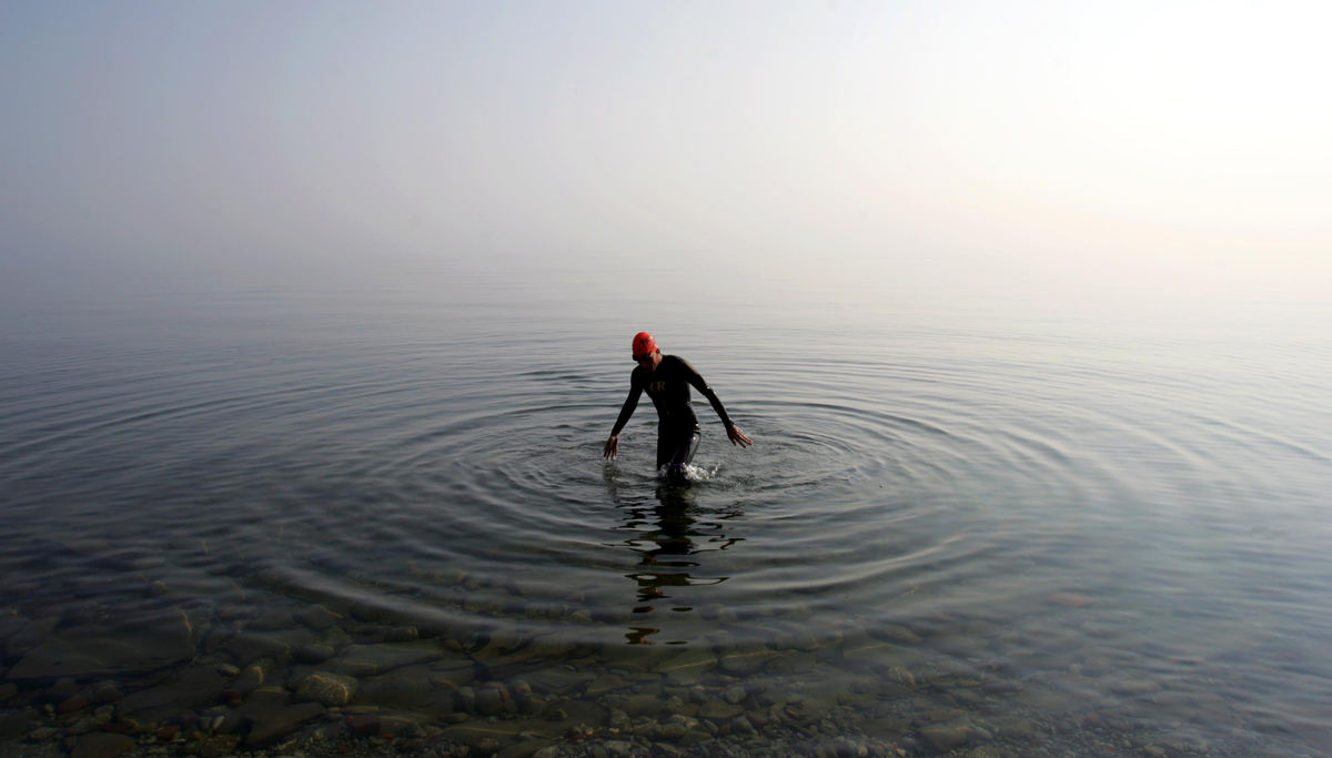 Award of Excellence, George S. Smallsreed Photographer of the Year Award - Dale Omori / The Plain DealerSwimmer Tom Seabold, 44, emerges from Lake Erie after an early morning workout.  Hot weather created a haze over the water obscuring the horizon.                                 