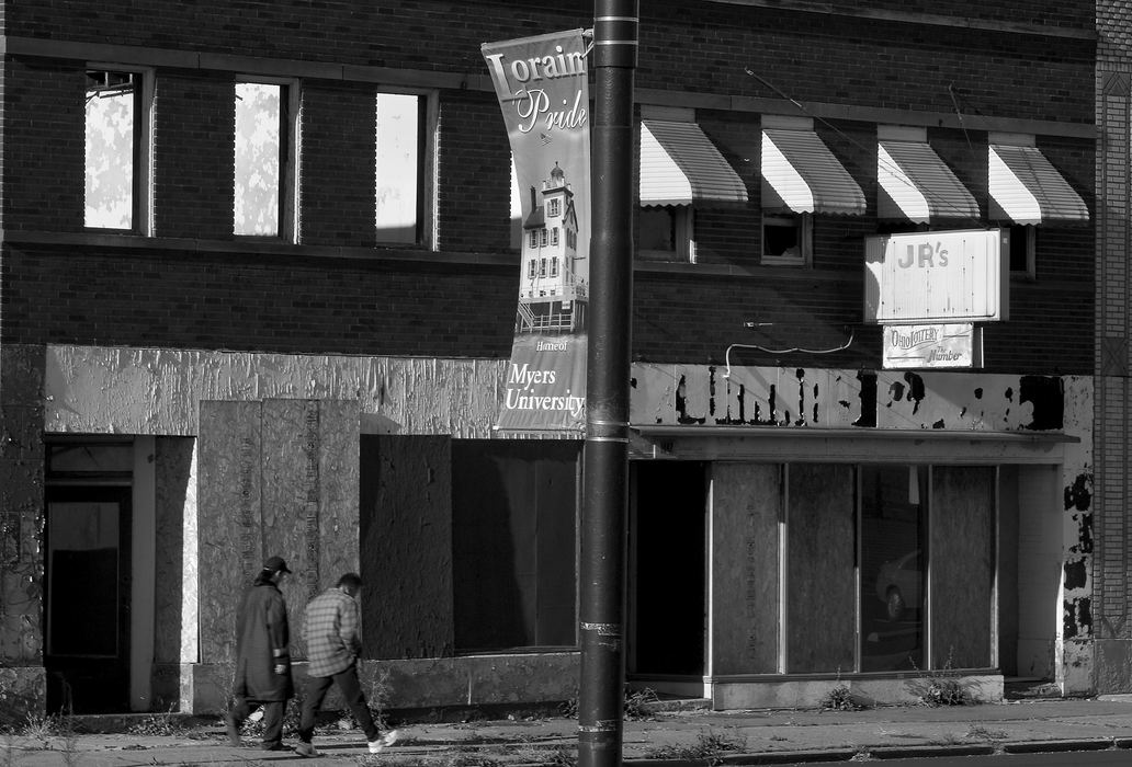 First place, George S. Smallsreed Photographer of the Year Award - Mike Levy / The Plain DealerSymbols of pride conflict with the deteriorating reality of downtown Lorain. 