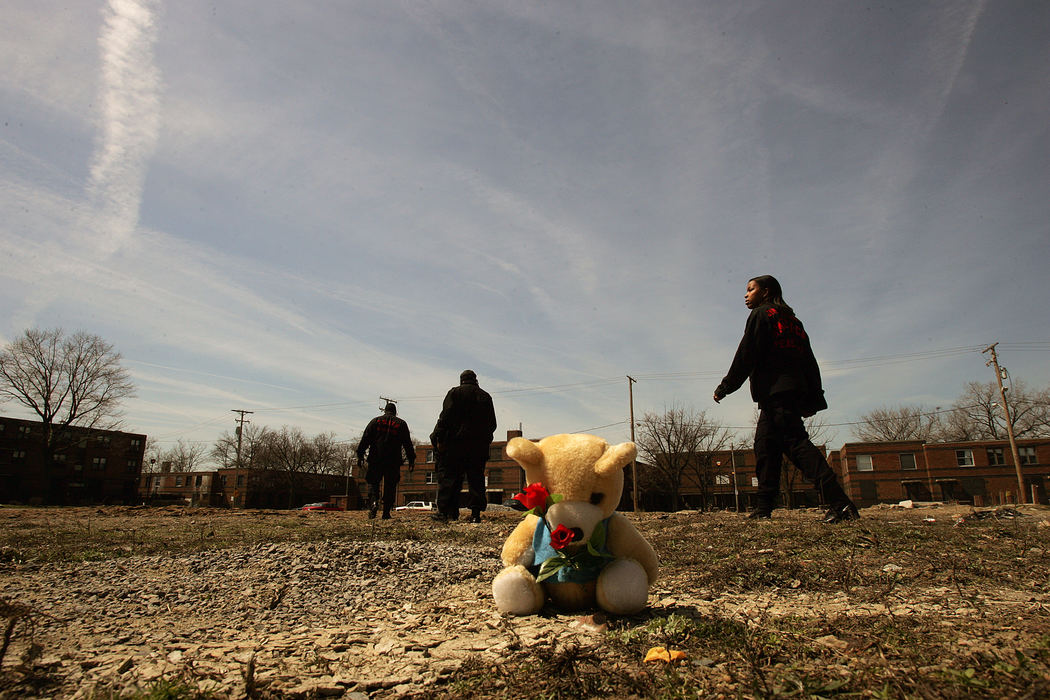 First place, George S. Smallsreed Photographer of the Year Award - Mike Levy / The Plain DealerMembers of the community task force walk around the area where 11-year-old  Brandon Davis was fatally shot near a playground at the Outhwaite housing project in Cleveland. 