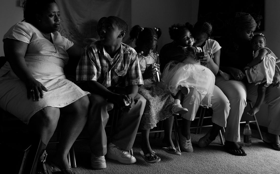 First place, George S. Smallsreed Photographer of the Year Award - Mike Levy / The Plain DealerA small group gathers before a church service held inside a small Elyria, Ohio apartment building.