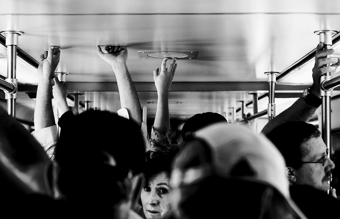 Second Place, George S. Smallsreed Photographer of the Year Award - Greg Ruffing / FreelancePassengers squeeze in and hold on tight during a crowded ride on a commuter train into Boston.