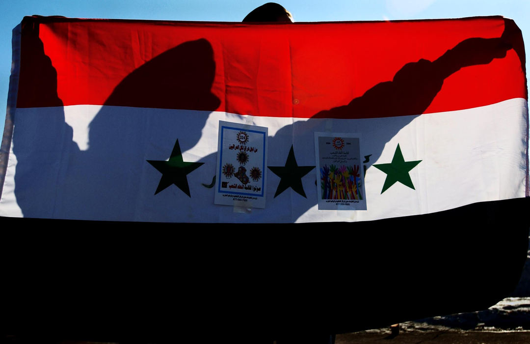 Second Place, George S. Smallsreed Photographer of the Year Award - Greg Ruffing / FreelanceMaher Shallal of Sterling Heights, Mich., waves the Iraqi flag outside a polling site in Detroit as Iraqi expatriates in the United States took part in voting for Iraq's Transitional National Assembly in January. The small posters taped onto the flag are campaign leaflets for one of the election candidates. The historic vote began the process of Iraq's first free elections in more than 50 years.