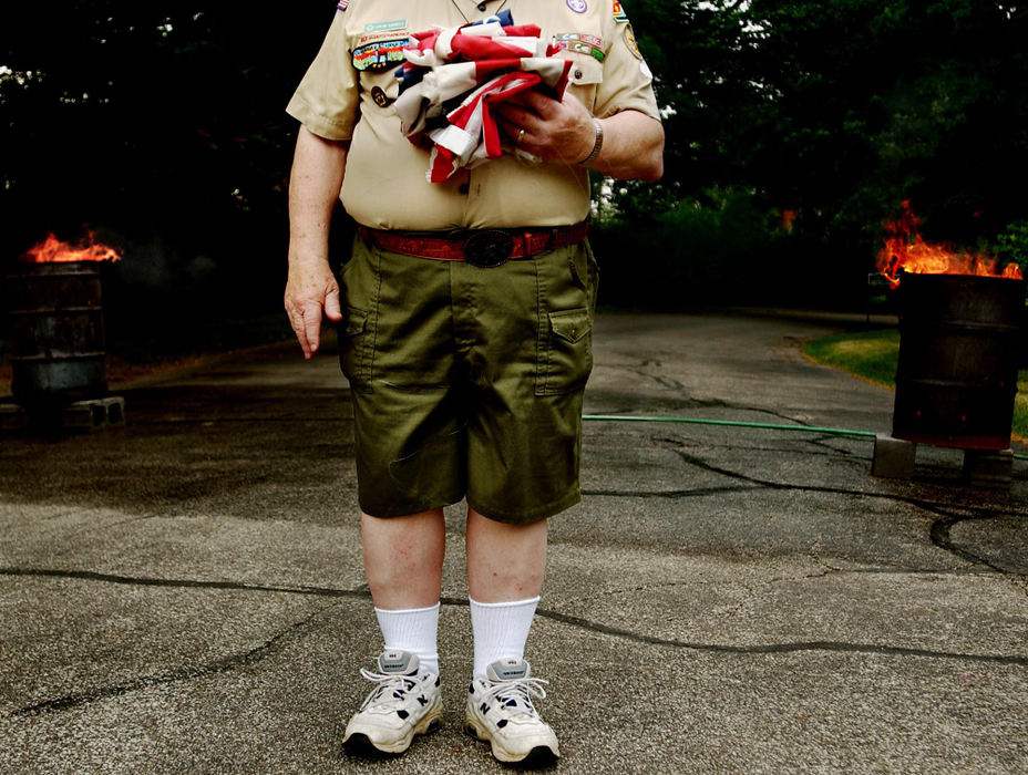 Second Place, George S. Smallsreed Photographer of the Year Award - Greg Ruffing / FreelanceBoy Scout troop leader Steve Szekely gathers the folded flags to be burned during a flag retirement ceremony on Flag Day at Lakeview Cemetery in Cleveland.