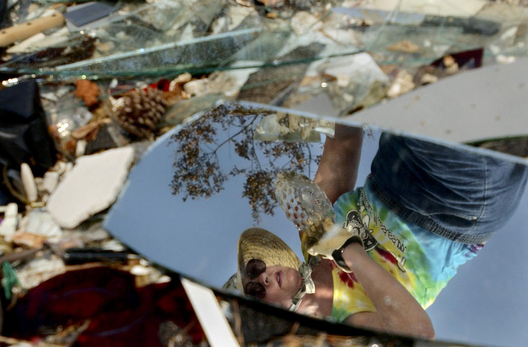 Second Place, George S. Smallsreed Photographer of the Year Award - Greg Ruffing / FreelanceLinda Myers is reflected in pieces of a broken mirror as she sifts through the remains of her parents' house in Waveland, Miss., in the aftermath of Hurricane Katrina. Ms. Myers' own house was along the same street; both house were completely destroyed as the eye of the storm struck just west of Waveland.