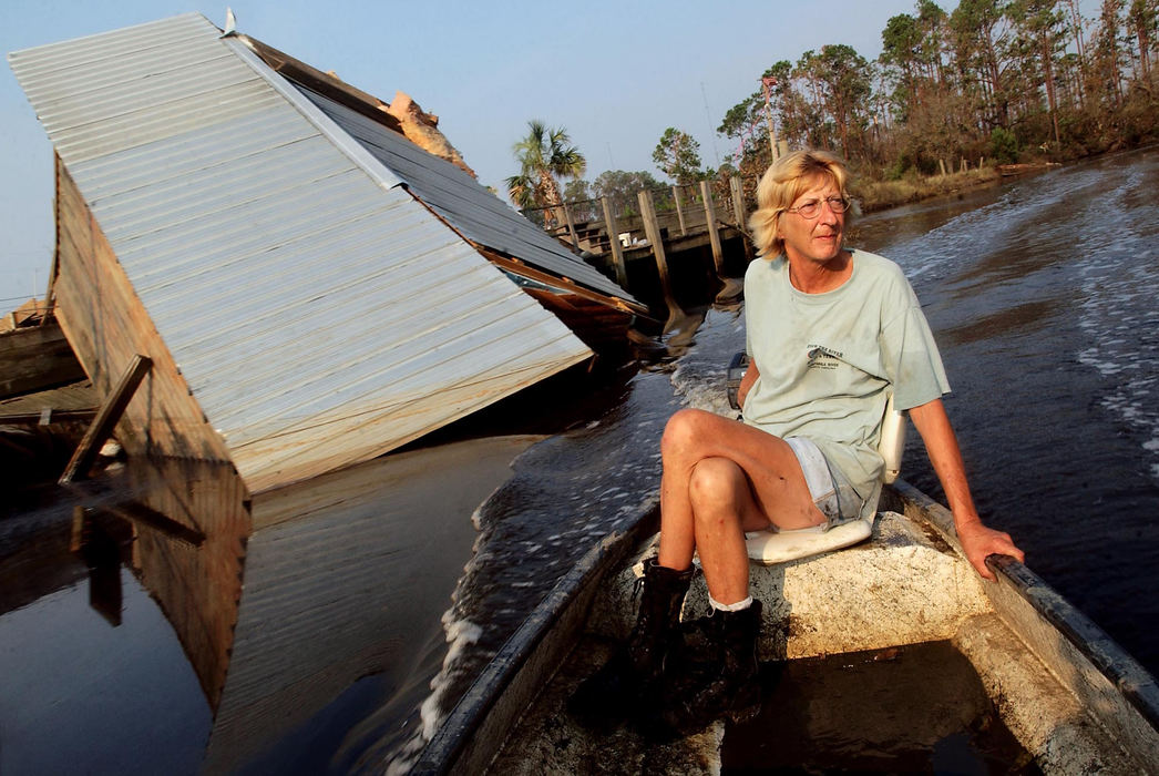 Second Place, George S. Smallsreed Photographer of the Year Award - Greg Ruffing / FreelanceSherri Higgins cruises through a bayou on a motorized canoe to go check up on one of her neighbors in Bay St. Louis, Miss. Her home was damaged by Hurricane Katrina and now she and her husband are living out of their car; the canoe is now their main mode of transportation. At left is a cabin that was damaged by the storm and pushed into the bayou.