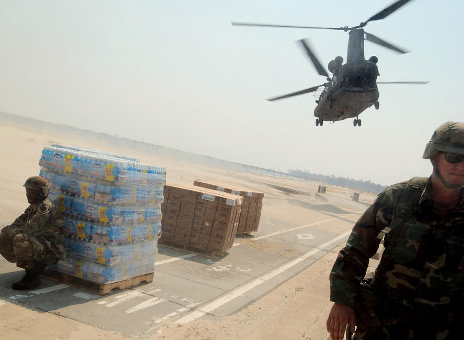 Second Place, George S. Smallsreed Photographer of the Year Award - Greg Ruffing / FreelanceNational Guard troops take cover as an Army helicopter takes off after unloading food, water and other relief supplies on the beach in Waveland, Miss. As many disaster relief services were concentrated in New Orleans, supplies and distribution in Mississippi were sometimes stalled, much to the frustrations of survivors there.