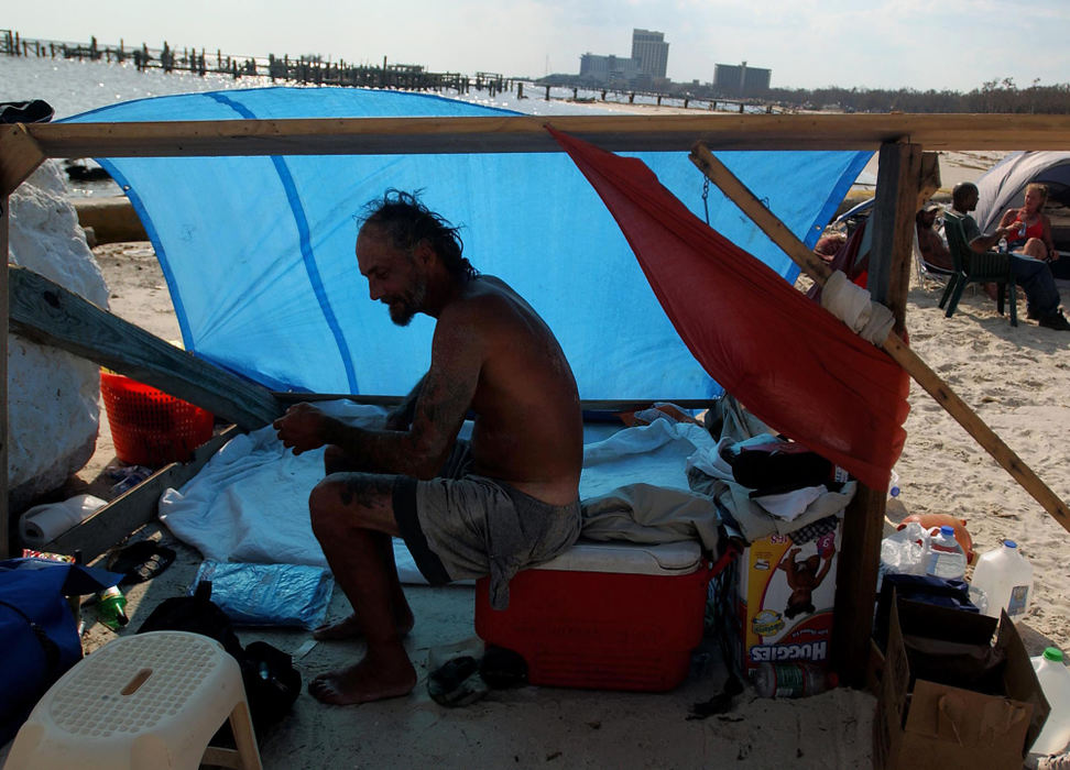 Second Place, George S. Smallsreed Photographer of the Year Award - Greg Ruffing / FreelanceLeft homeless by Hurricane Katrina, Royce Davis (foreground) and a small group of other residents of Biloxi, Miss., have been living in a makeshift camp along the city's Gulf coast beach.