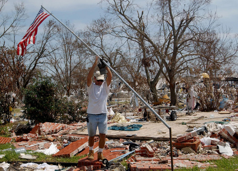 Second Place, George S. Smallsreed Photographer of the Year Award - Greg Ruffing / FreelanceMark Oehmichen replaces the flag in front of the remnants of his family's house in Long Beach, Miss. In the days following the hurricane, survivors had to decide how to rebuild their lives and homes. For many, the defiant choice was to rebuild atop the landscape flattened by the storm.