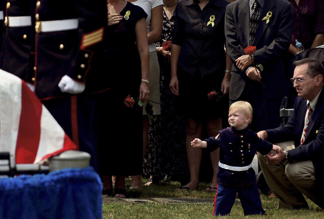 Second Place, George S. Smallsreed Photographer of the Year Award - Greg Ruffing / FreelanceDressed in a small Marines uniform, Alexander Montgomery, the 1-year-old son of Lance Cpl. Brian Montgomery, looks toward his father's casket during funeral services in Chester Township. Lance Cpl. Brian Montgomery was one of 20 Ohio-based Marines from the 3rd Battalion, 25th Regiment killed in the Iraq war. His brother, Lance Cpl. Eric Montgomery (not pictured), serves in the same Marine unit. 