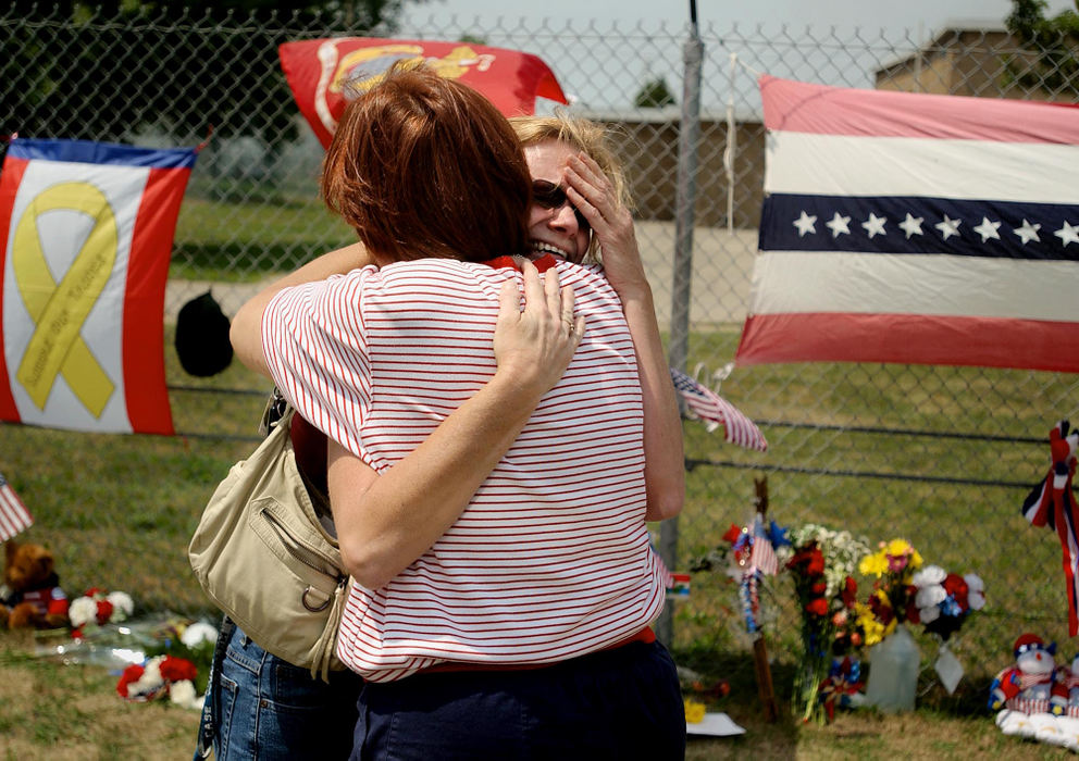 Second Place, George S. Smallsreed Photographer of the Year Award - Greg Ruffing / FreelanceCarleen Gulley (facing camera) of Mantua, is consoled by Judy Mirtell of Brookpark, as she weeps next to a memorial site outside the Col. Justice M. Chambers U.S. Marine Corps Reserve Center in Brookpark. The center is headquarters for the Marines 3rd Battalion, 25th Regiment. Ms. Gulley's son is scheduled to be deployed to Iraq in January.