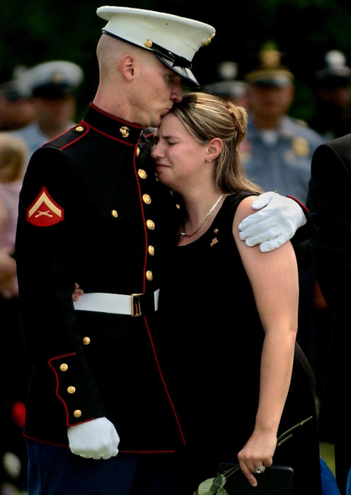 Second Place, George S. Smallsreed Photographer of the Year Award - Greg Ruffing / FreelanceMarine Lance Cpl. Eric Montgomery (left) consoles his sister-in-law Pam Montgomery as family members mourn during funeral services for Lance Cpl. Brian Montgomery (Pam's husband and Eric's brother).