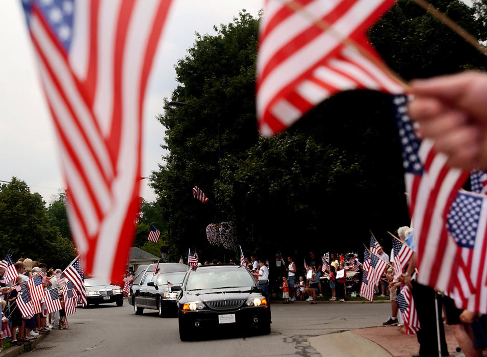 Second Place, George S. Smallsreed Photographer of the Year Award - Greg Ruffing / FreelanceHundreds of people line the street along the historic Tallmadge Circle to show their support during the funeral procession of Lance Cpl. Daniel Nathan Deyarmin Jr. Deyarmin, who had lived his whole life in the small town, was one of 20 Ohio-based Marines from the 3rd Battalion, 25th Regiment killed in the Iraq war.